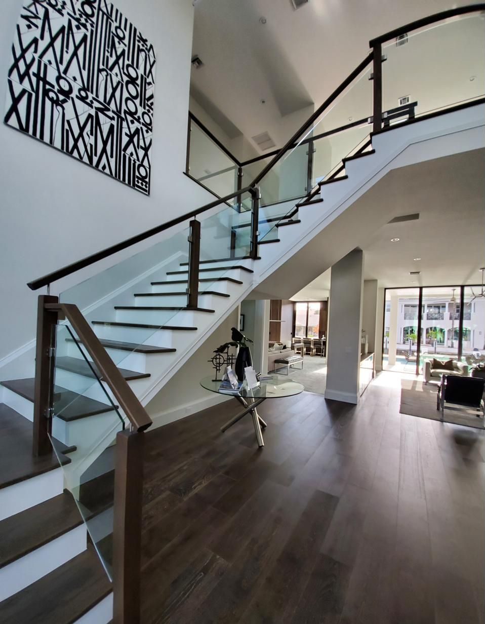Curving staircase with glass panel railing