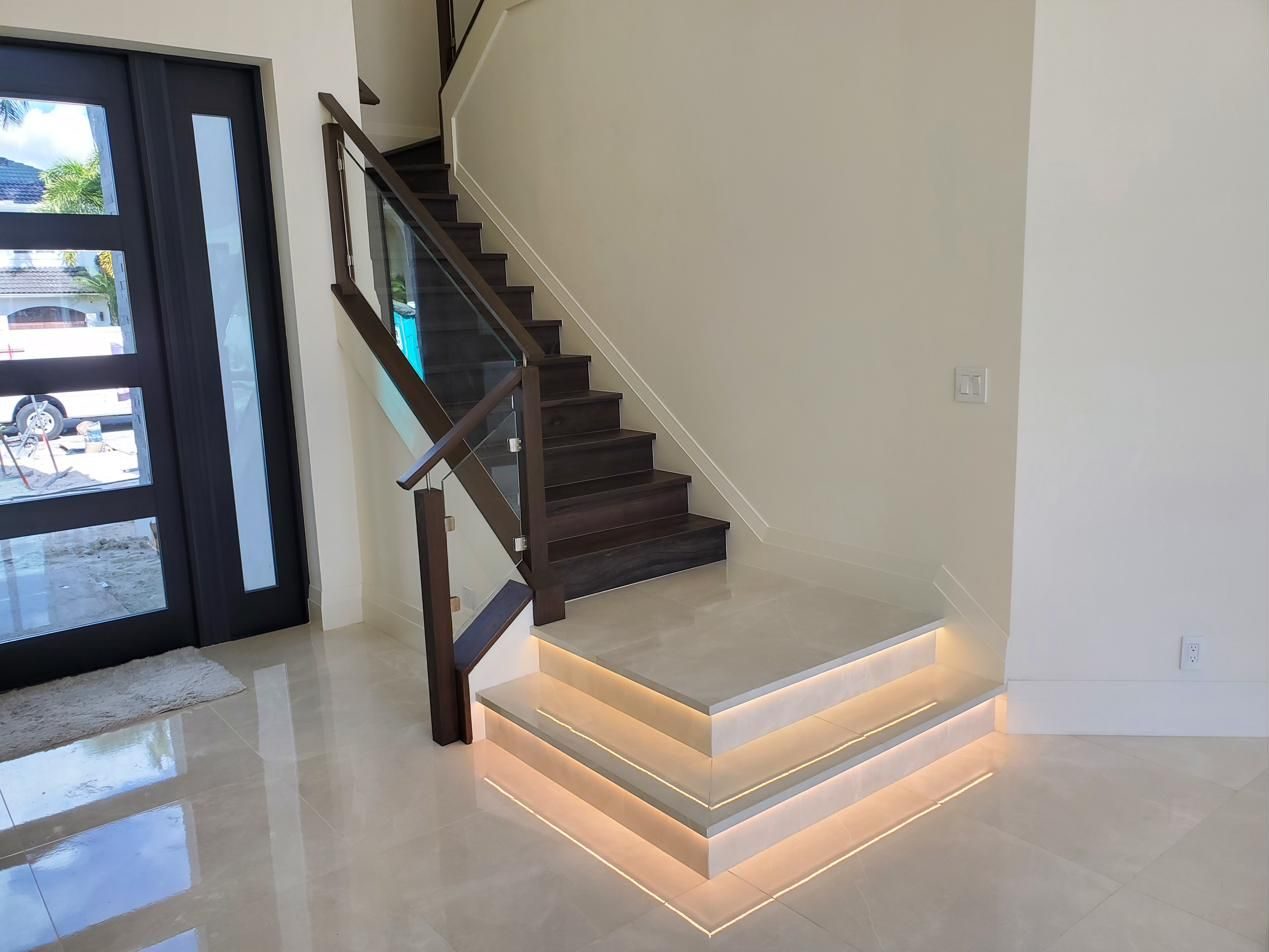 Glass-railed staircase with lit base