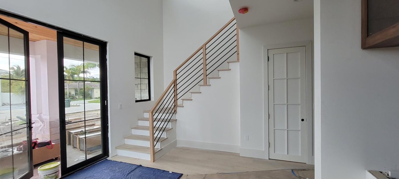 Staircase with horizontal metal rod railing