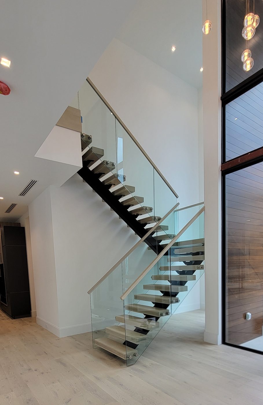 Floating staircase with frameless glass railing