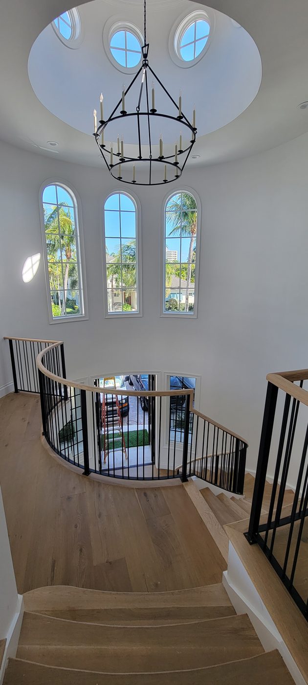 Curved staircase beneath a domed ceiling