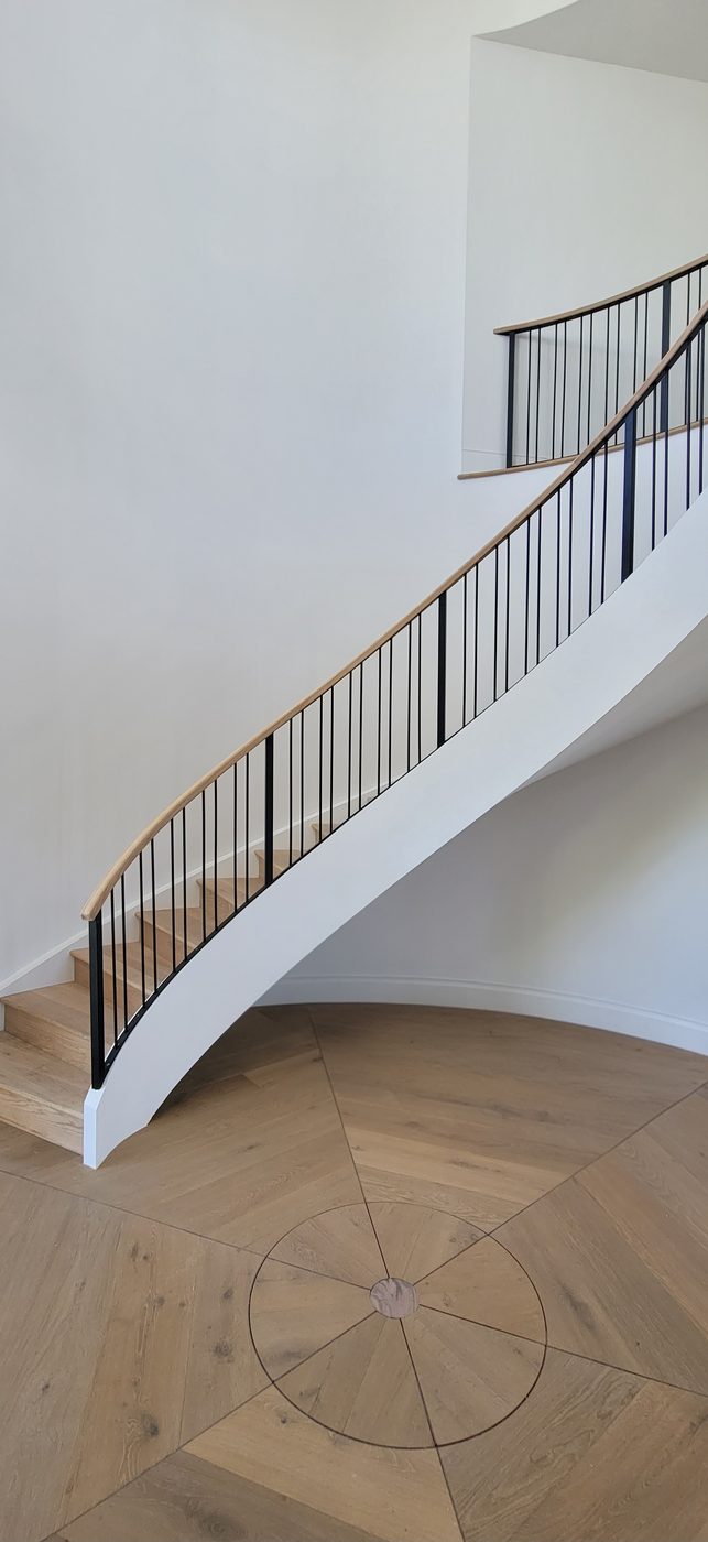 Circular staircase with wood floor medallion