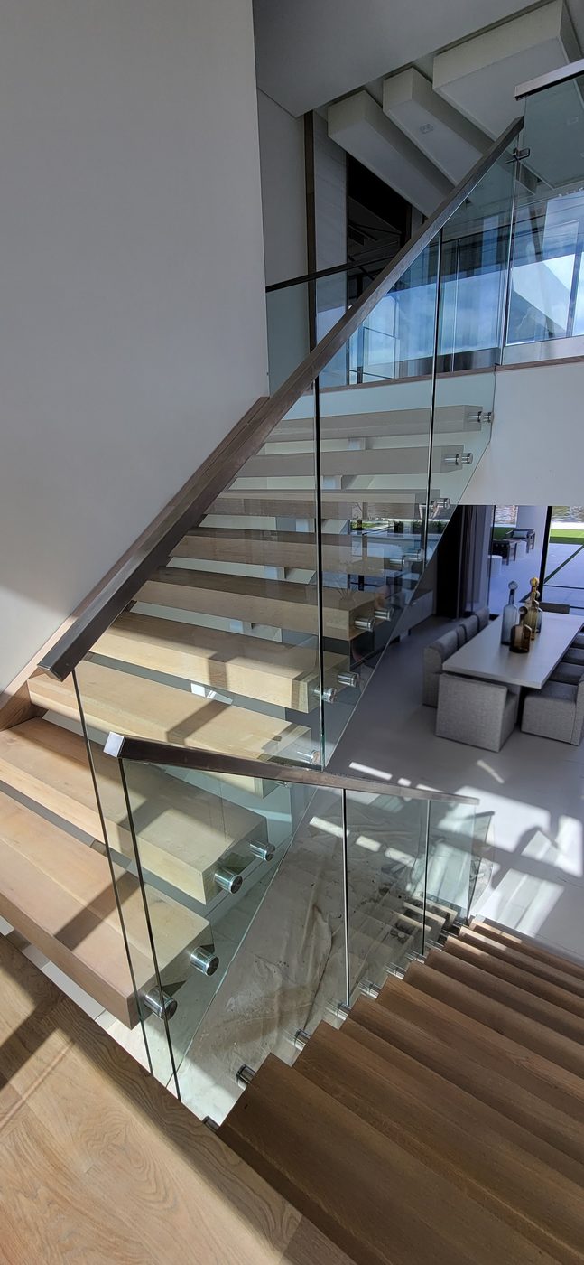 Floating staircase with frameless glass railing