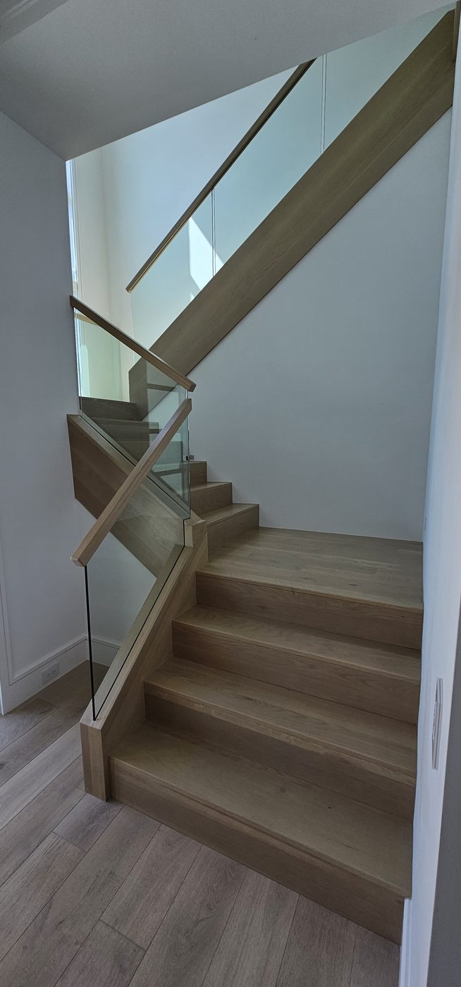 Frameless glass railing along a mezzanine landing