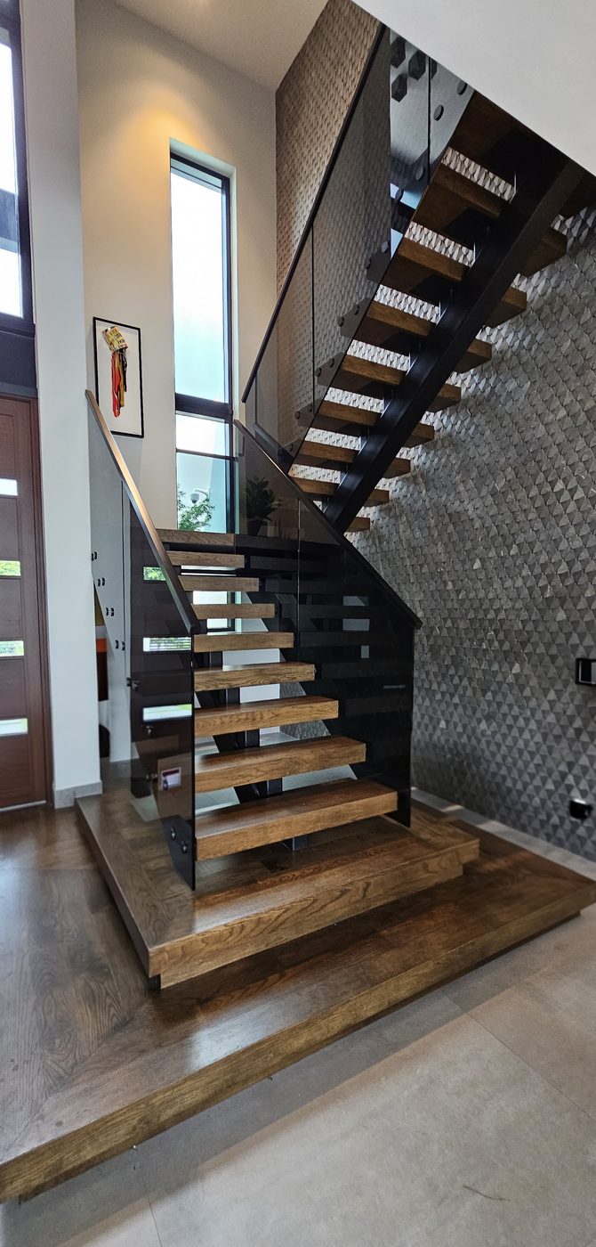 Floating staircase with tinted glass railing