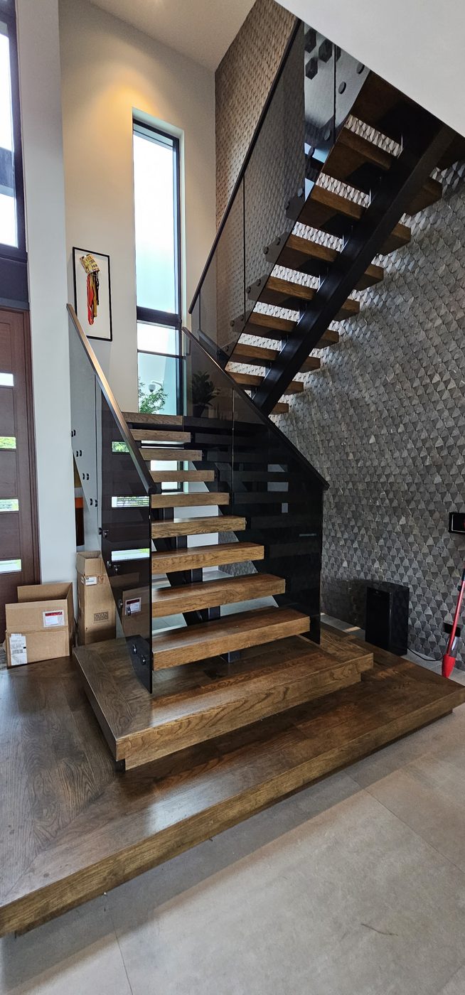 Floating staircase on a wood platform with tinted glass