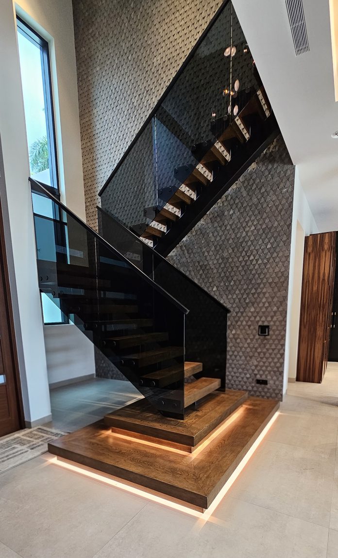 Floating staircase with wood treads, steel stringer and tinted glass