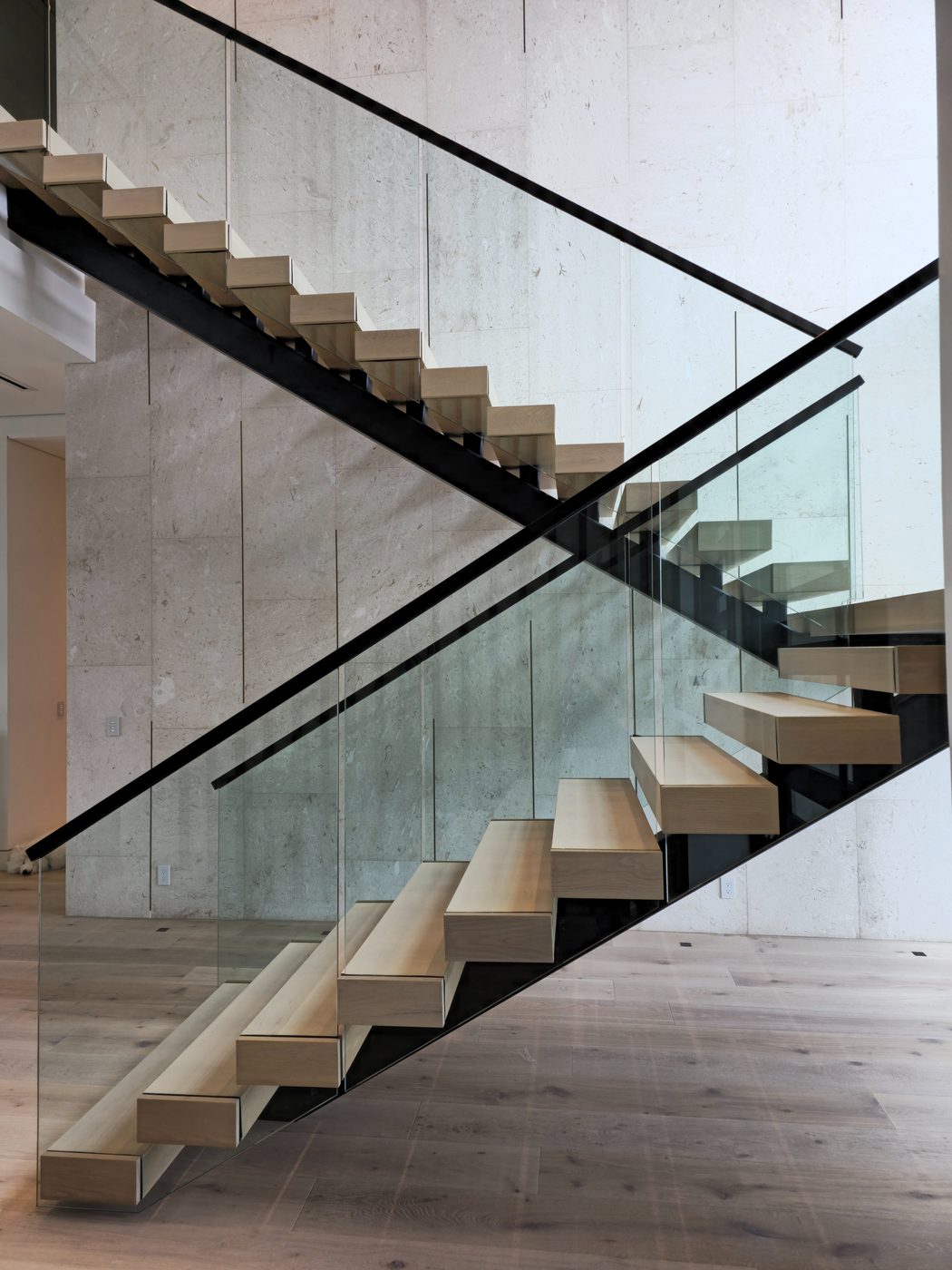 Floating staircase with frameless glass railing