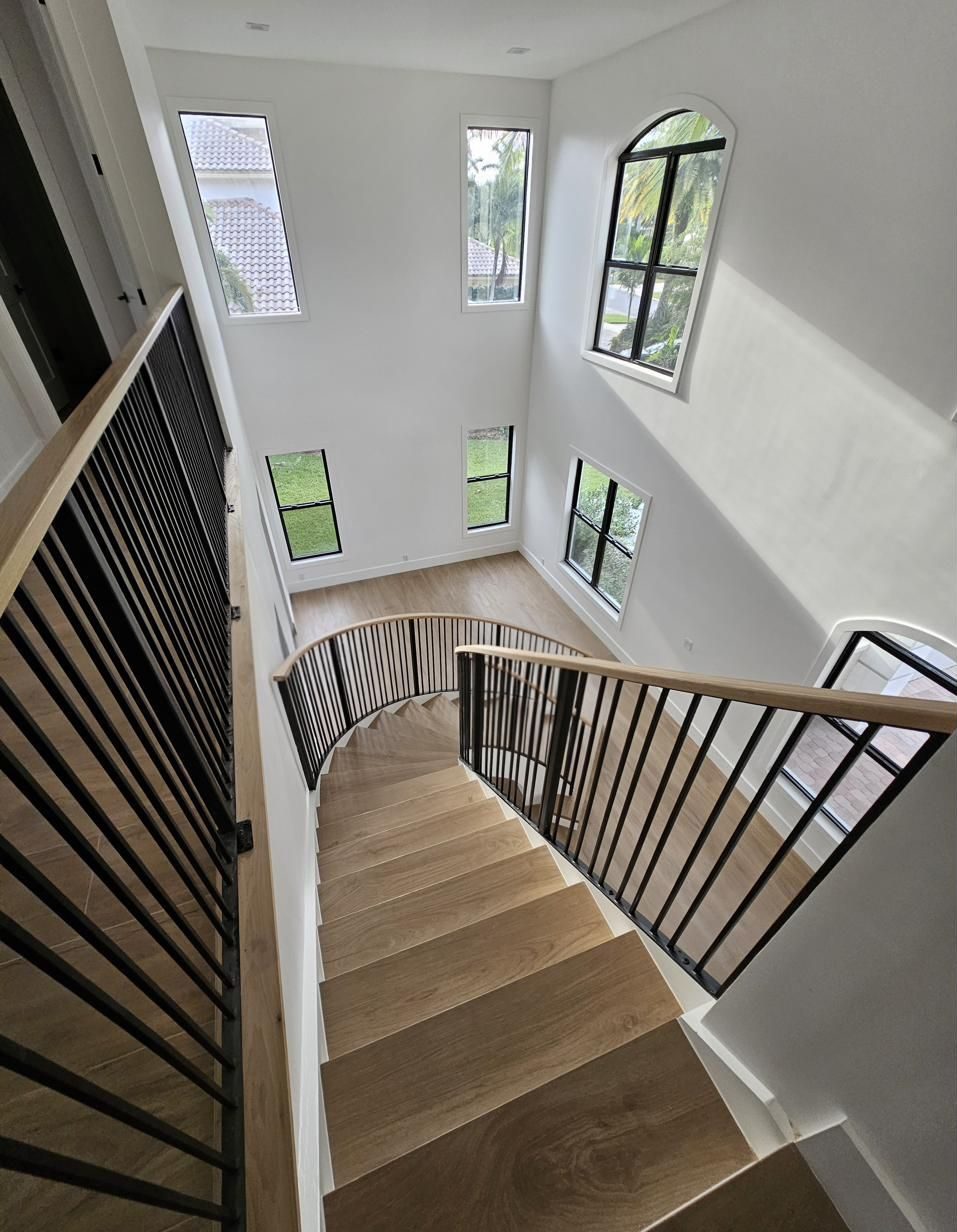 Curved staircase with iron balusters, detail
