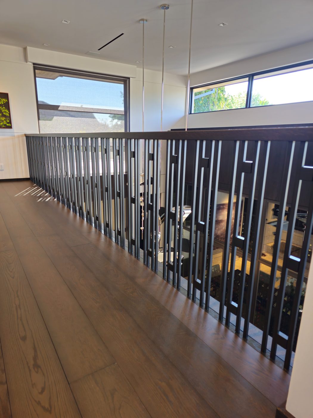 Metal rod railing along a floating staircase