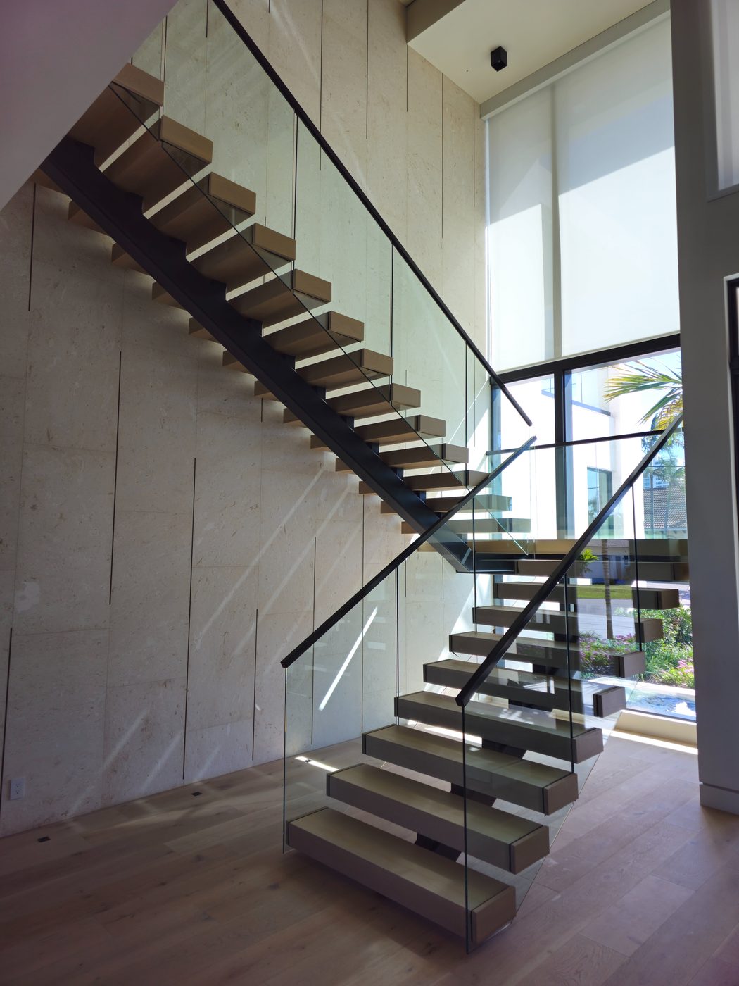 Floating staircase against a limestone wall
