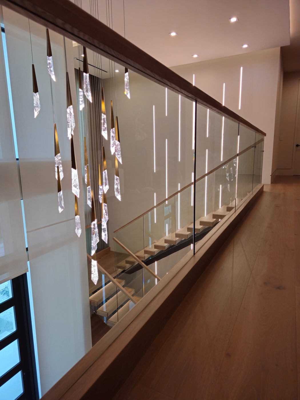 Floating staircase with wood treads and glass railing