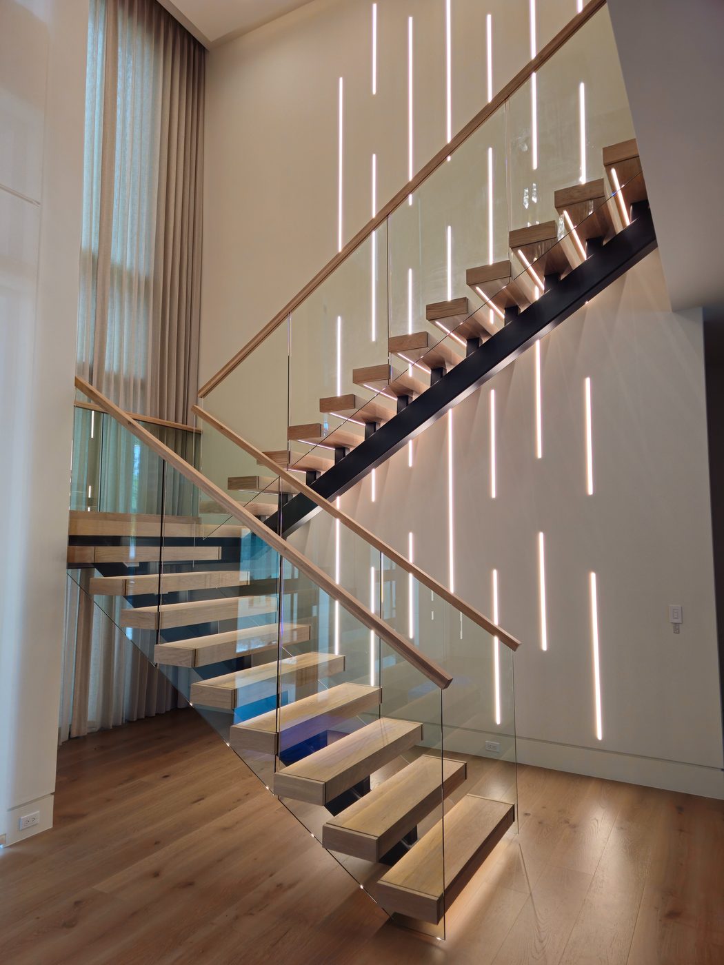 Floating staircase with backlit feature wall