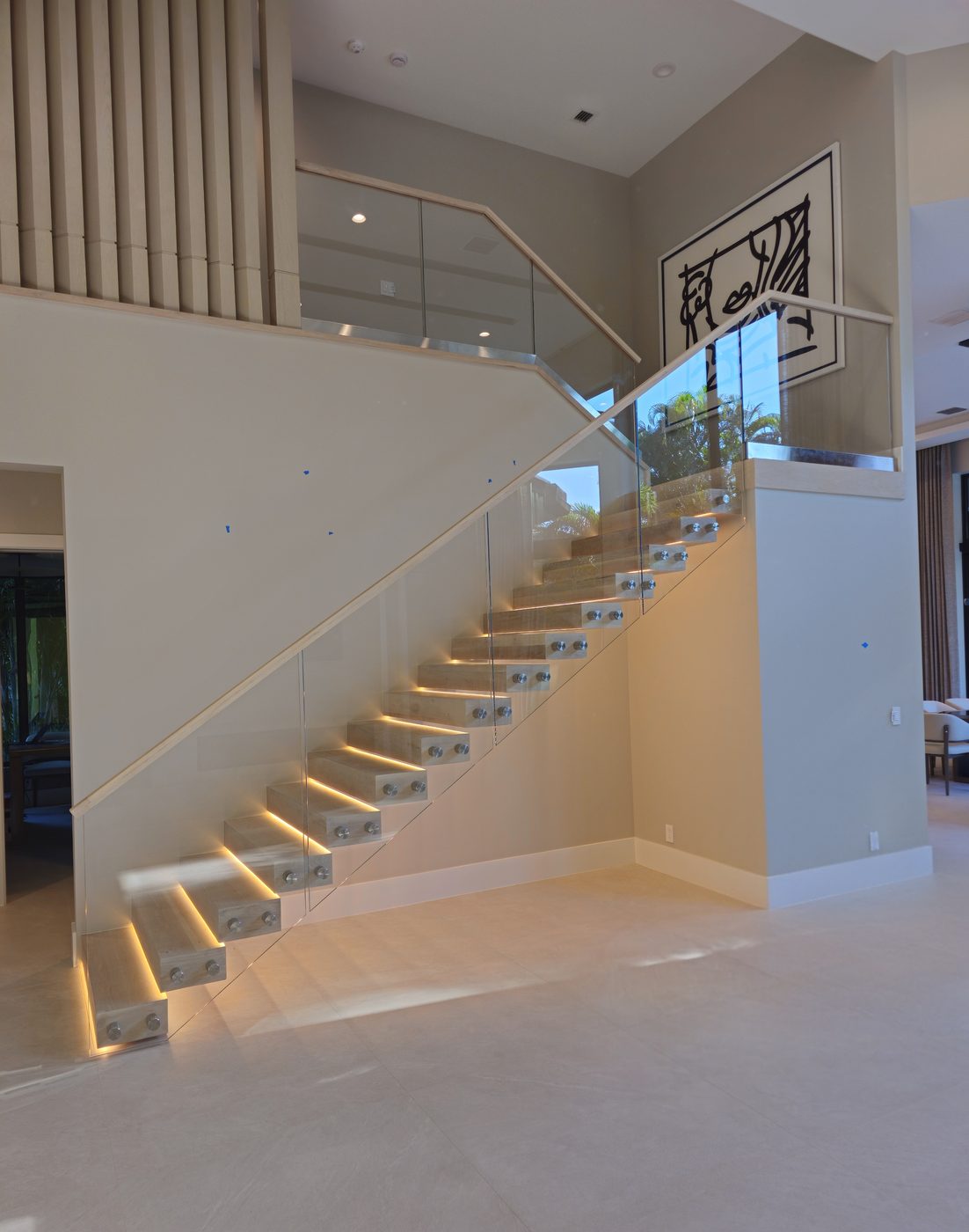 Floating staircase with under-tread lighting