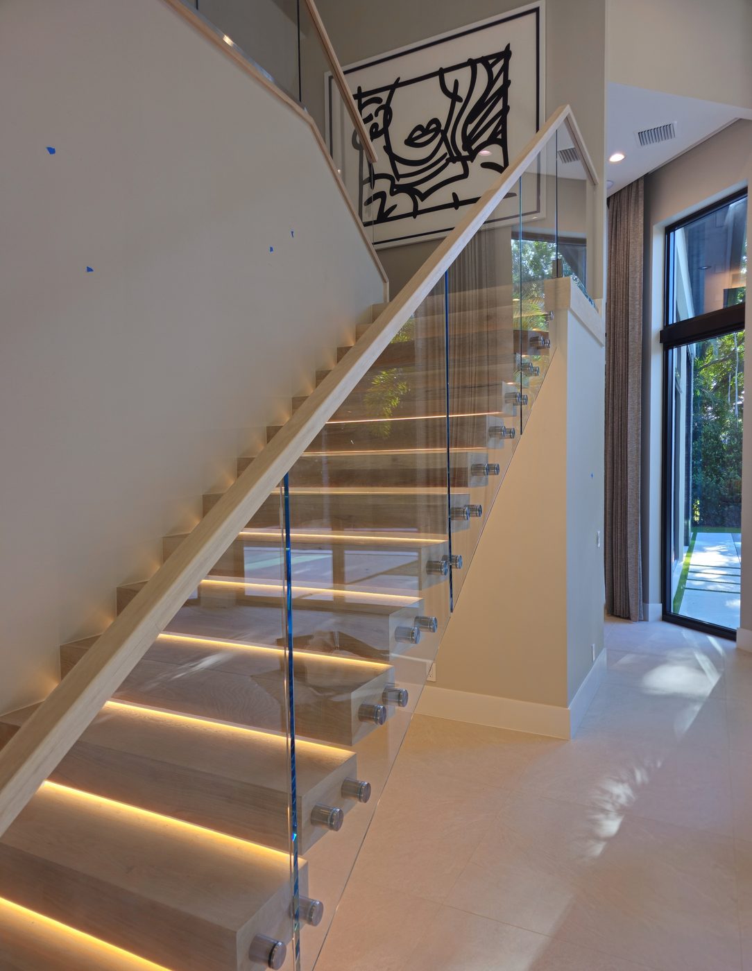 Modern floating staircase with glass railing