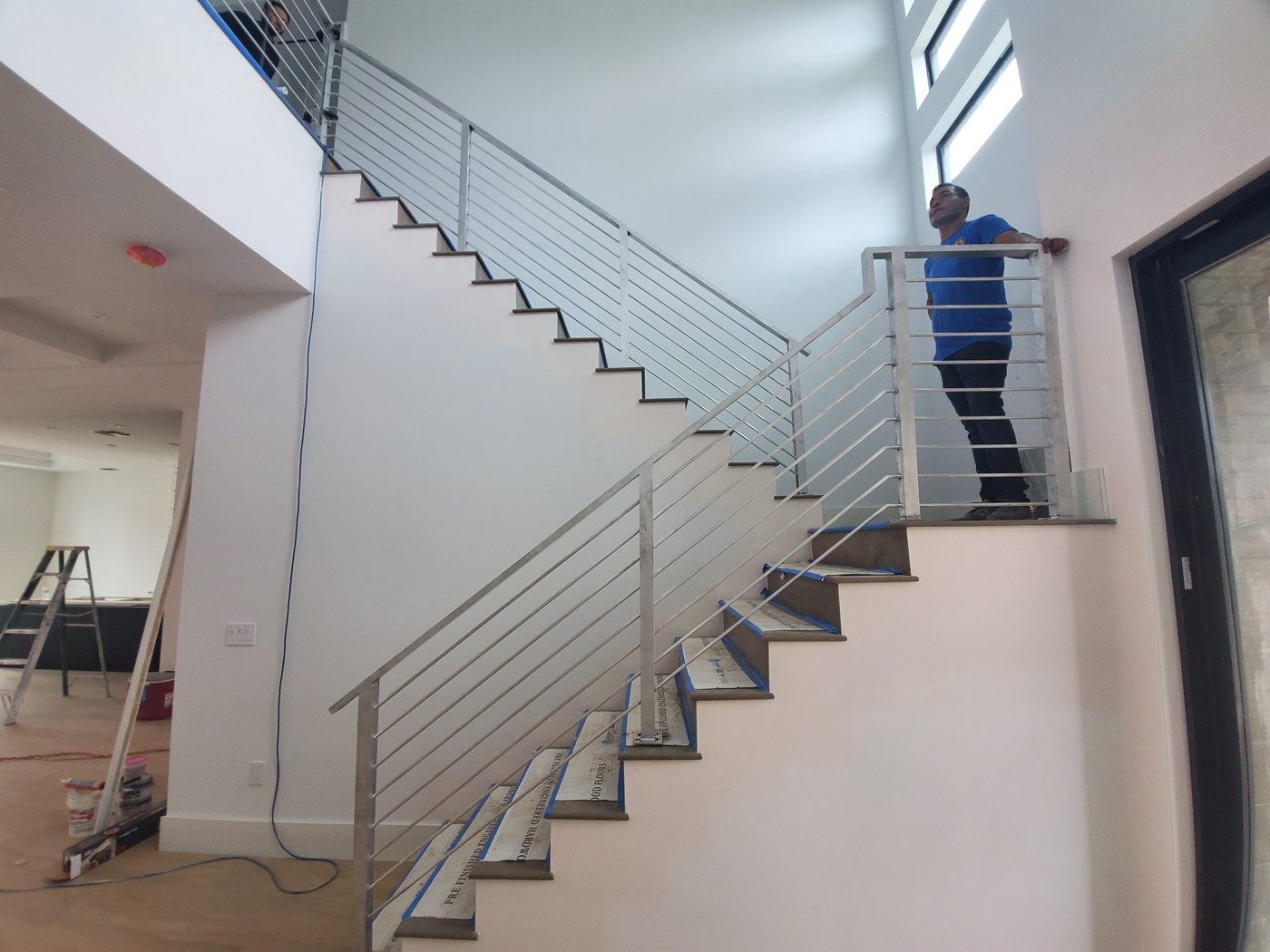 Steel horizontal rod railing along a staircase