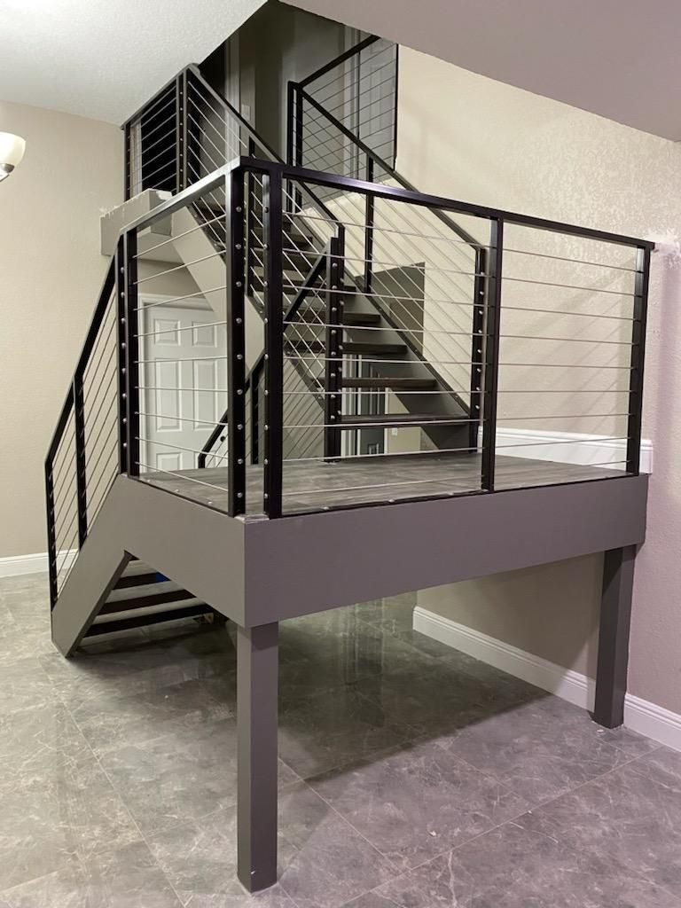 Steel staircase with cable railing and landing